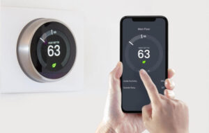 Smart thermostat being adjusted by a smart phone